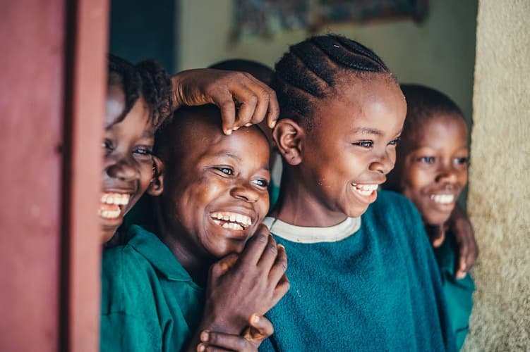 image of children smiling at a scene